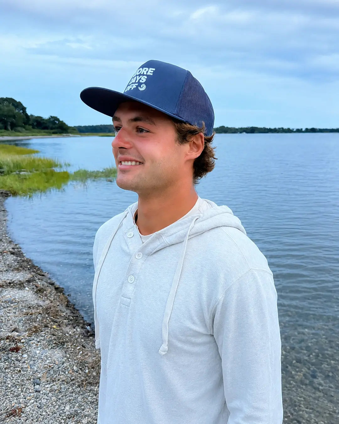 Side view of model wearing the navy More Days Off hat