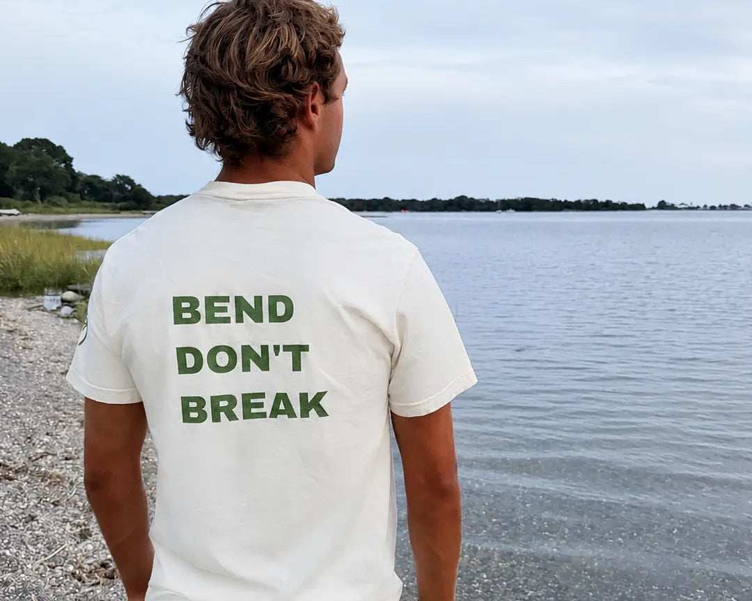 Back view of the ivory tee with green Bend Don't Break print