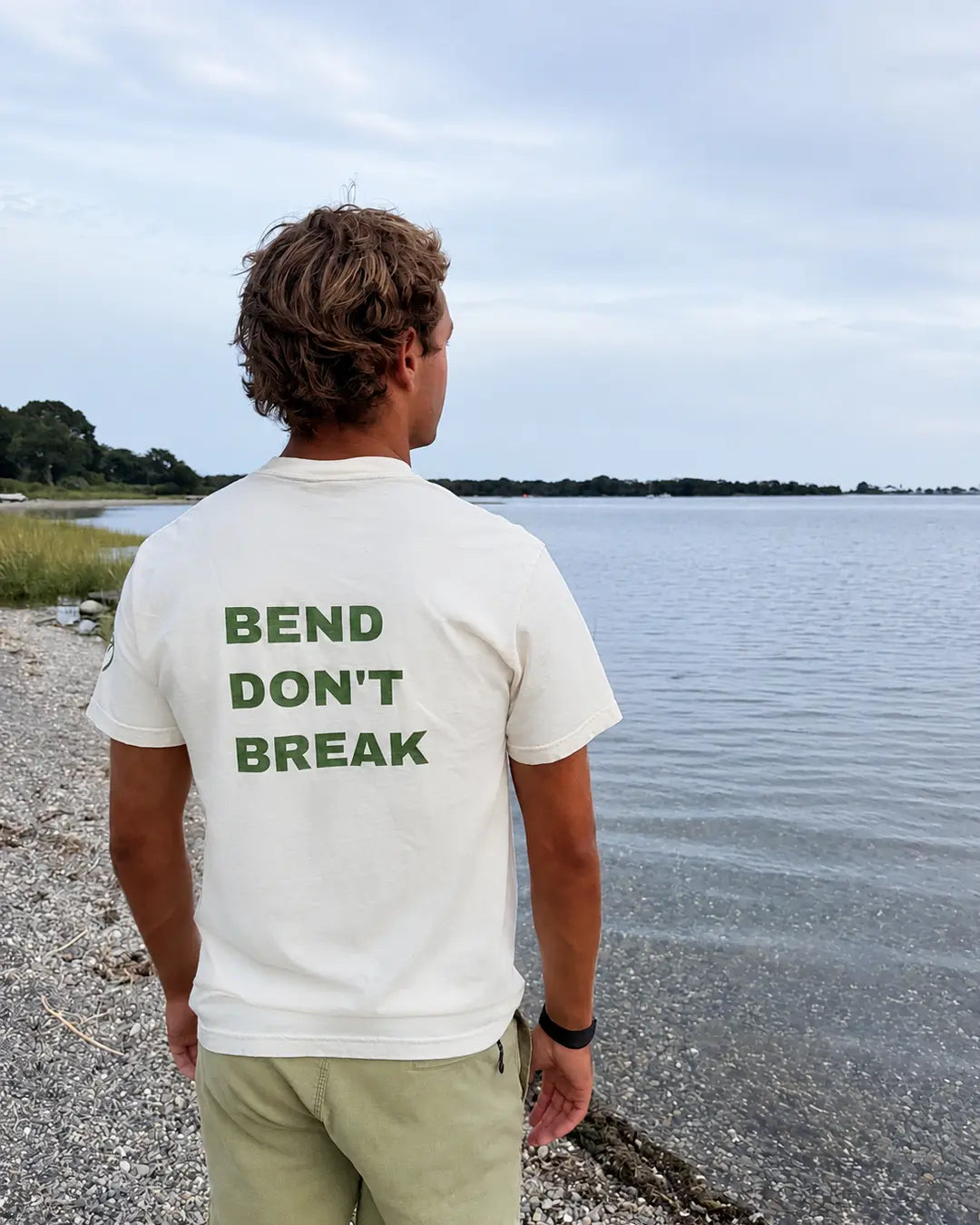 Back view of the ivory tee with green Bend Don't Break print