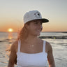 Close-up right-side view of the Blue Ocean Life Wellness Club Snapback Hat at sunset