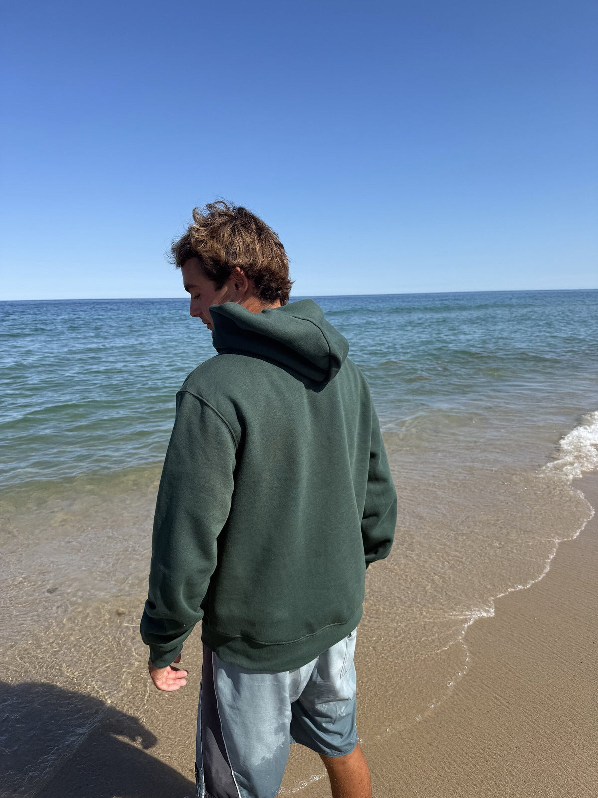 Healing Wave embroidered hoodie in forest green back lifestyle view