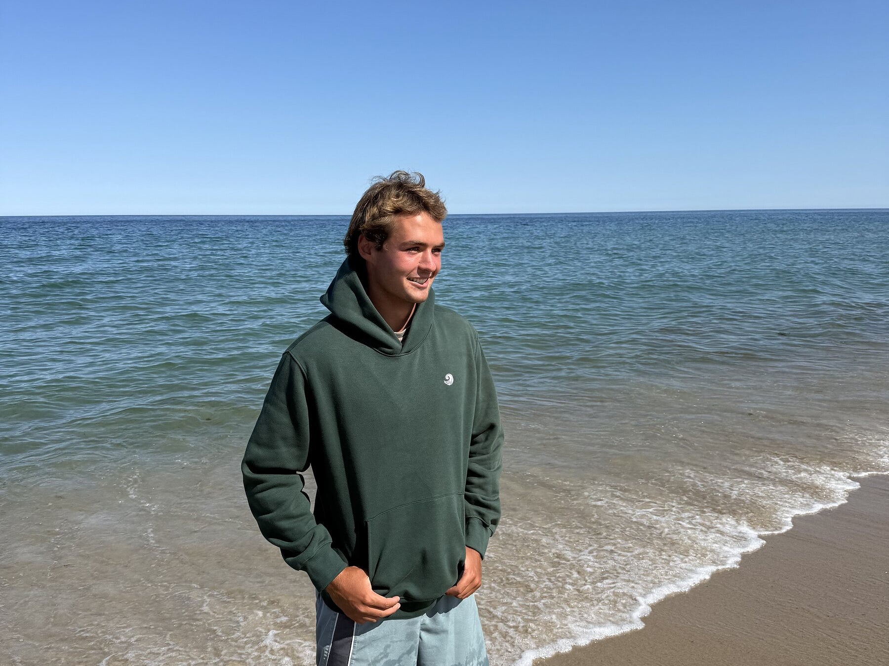Healing Wave embroidered hoodie in forest green front lifestyle view