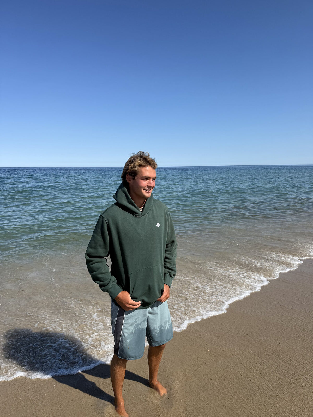 Healing Wave embroidered hoodie in forest green front lifestyle view