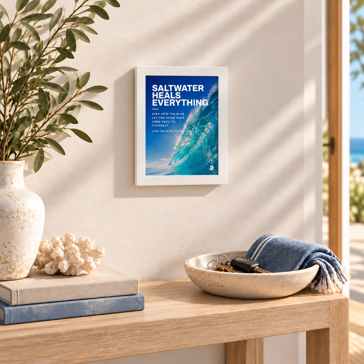 Compact Saltwater Heals Everything framed print above a coastal console